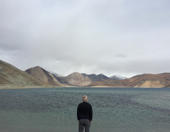 Large canva   man traveler standing alone on cliff lake and foggy mountains on