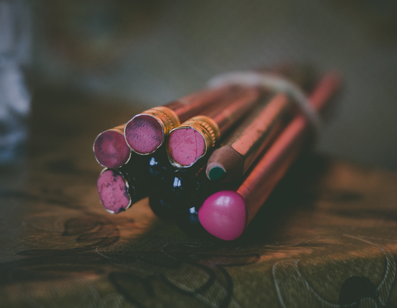 Large canva   wrapped purple pencils on table