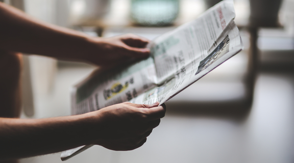 Homepage canva   person reading a newspaper