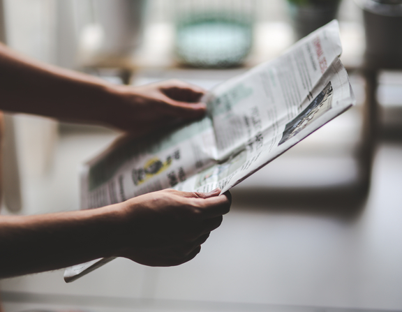 Large canva   person reading a newspaper