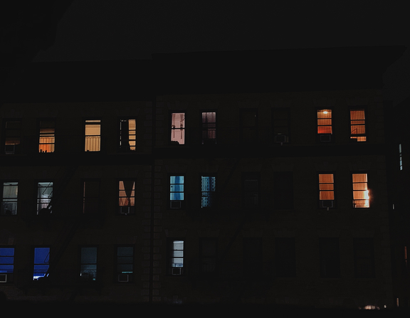 Large canva   multi storey building with open windows during nighttime