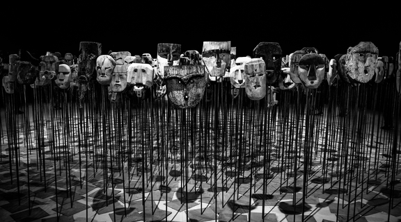 Homepage canva   greyscale photo of masks on a stick